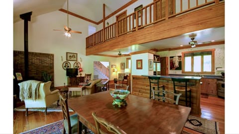 Open living, dining, kitchen, breakfast area with vaulted ceilings.
Open to deck