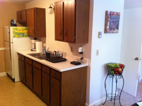 Kitchen is outfit with coffee maker, grinder, full sized fridge and range.