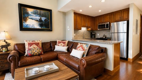 Sink into rich leather sofas and enjoy the open layout connecting your living space to a fully equipped kitchen with granite counters and stainless steel appliances.
