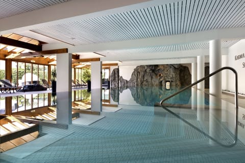 Indoor pool, open 7:00 AM to 10:00 PM, pool umbrellas, sun loungers