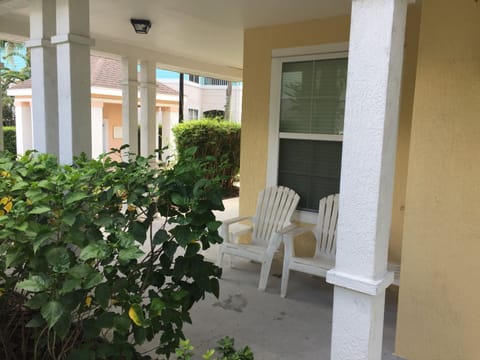 Private patio in front of condo that wraps around to the side.