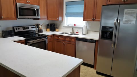 Kitchen is fully appointed with new stainless appliances and marble counter tops