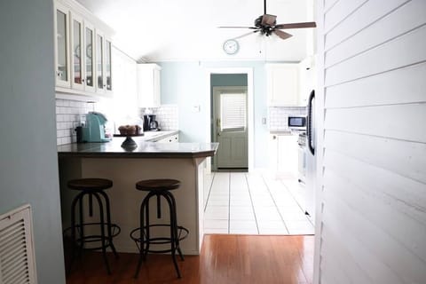 Kitchen w/ sink, dishwasher, 12-cup filter coffee maker, toaster, dishes, cups