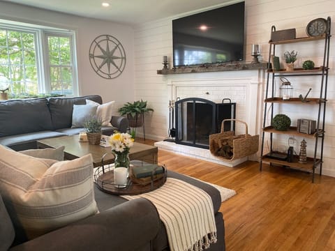 Living Room — Coastal grey sectional, a cozy fireplace, and nautical touches.