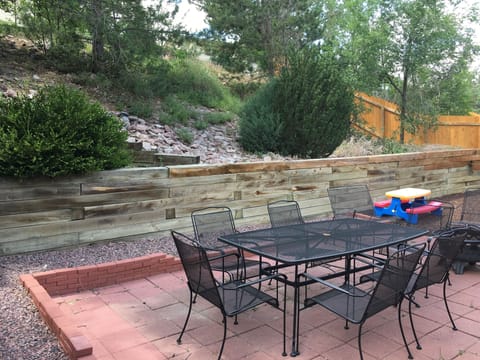 Backyard bluff with patio set
