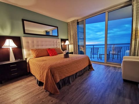 Elegant primary suite with stunning ocean views and private balcony access