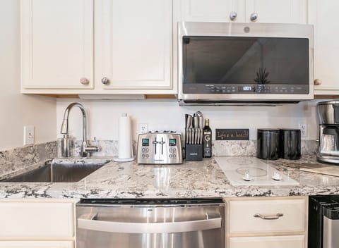 The unit features a dining table for four and a fully-equipped kitchen for your dining needs.