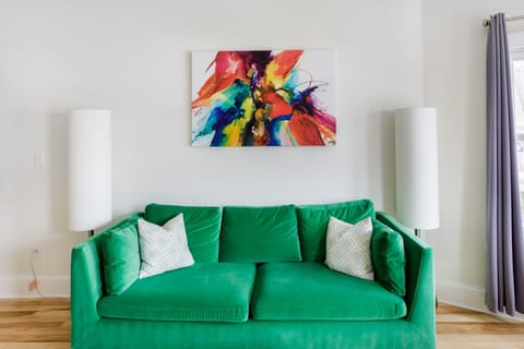 Relax in style on this vibrant green sofa with artistic flair!