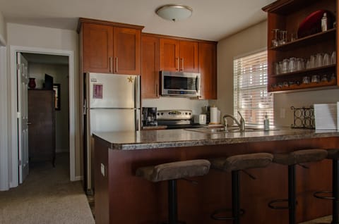 Updated kitchen with stainless-steel appliances, large countertop + 4 barstools