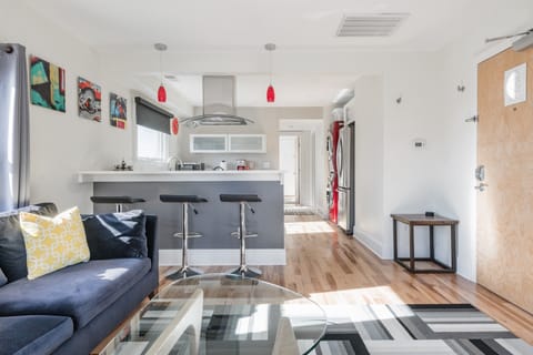 Sunlight pours through bay windows, illuminating the furnishings.