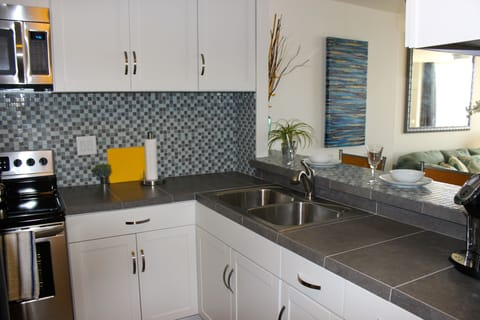 Brand new appliances, cabinets and counter tops