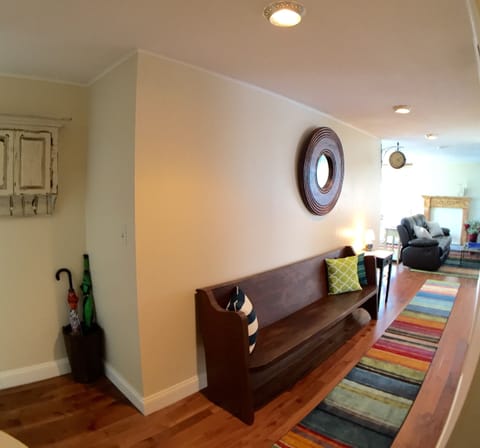 An old church pew greets you in the wide inner hall