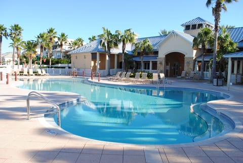 Family pool has beach style zero entry. Lakeside clubhouse in the background.