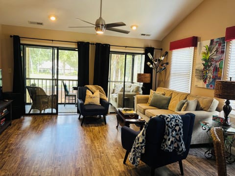 Living room w smart tv access to enclosed porch