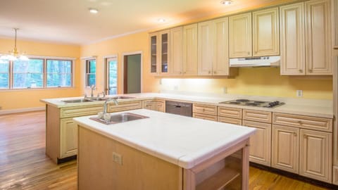 Large kitchen. Double ovens, triple sink, center of house, plenty of dishes.