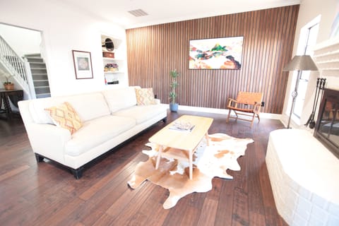 Living Room. With 65” frame tv. View to front hall and stairs.