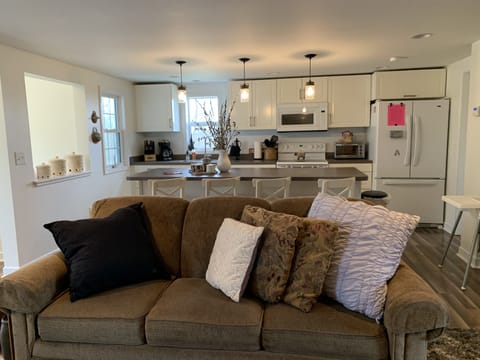 Cozy Living room open to kitchen with couch, recliner, DirecTV and internet. 