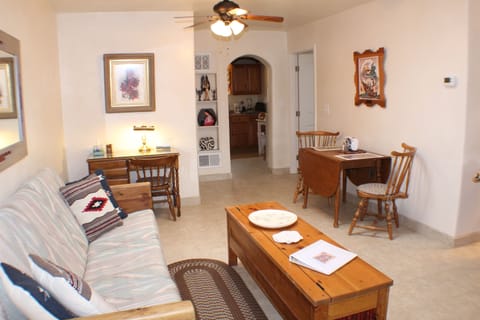 Living/dining area with small kitchen and bedroom nearby. 
