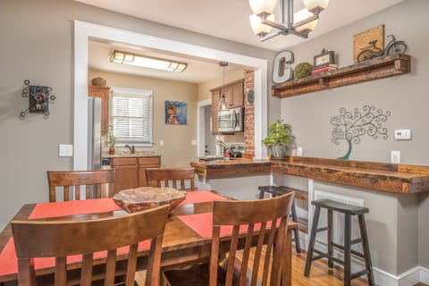 Our dining room has bar height seating for 4 and a handcrafted bar with stools. 