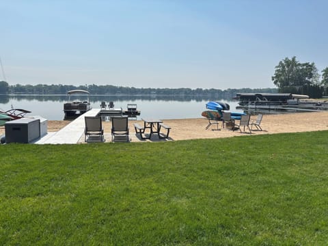 View from the yard to the beach/lake.  Beach/lake toys and fire pit.   