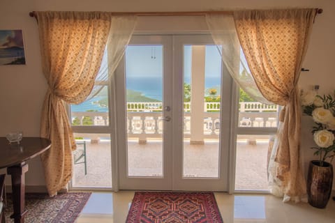 view of the harbor through the french doors of the living room