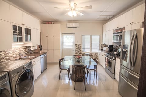 washing machine and dryer conveniently situated in the fully functional kitchen