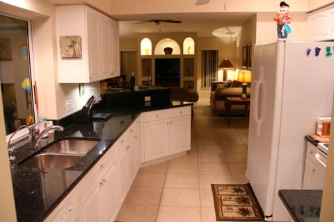 Well equipped kitchen with granite counters and pass-through to the pool.