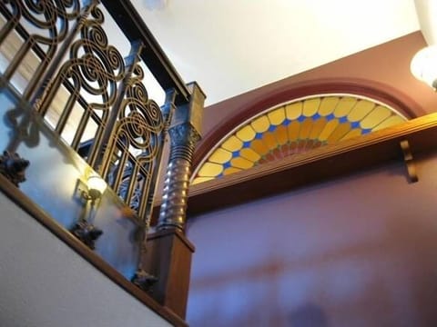 Stained Glass window and stair rail gaurd rail viewed from staircase