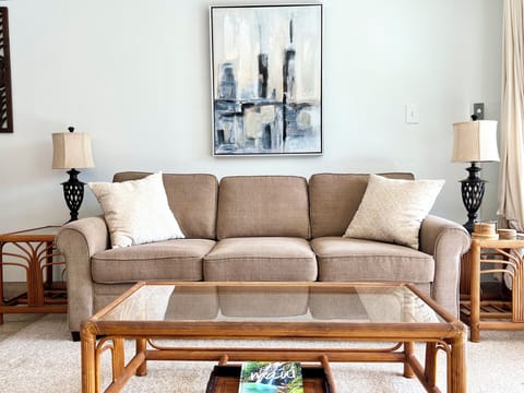 Living room with Queen sized sofa bed, A/C and ceiling fan.