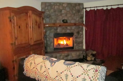 River rock wood burning fireplace.