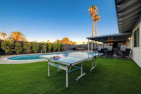 Private backyard with pool, outdoor seating, and games — perfect for relaxing Vegas days