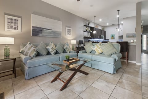 Bright modern living room with updated decor, comfortable seating, and smart TV