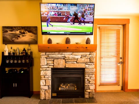 Giant 55-inch HDTV+Dish, bar, gas fireplace, and beautiful artwork await you!
