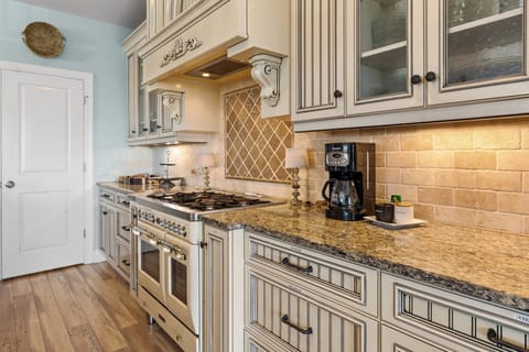 Gas stove with small oven for baking and a tiny side oven for reheating.