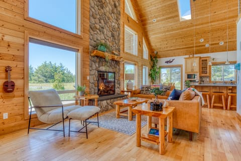 The great room has a beautiful floor to ceiling river rock fireplace