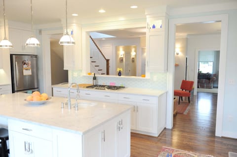 The kitchen has Carrera marble countertops and stainless steel appliances
