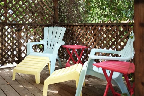 Adirondack chairs on the Star Jasmine covered front deck