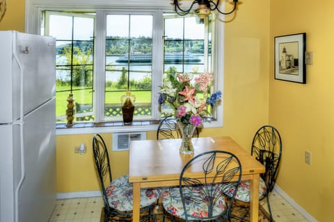 Kitchen dining table that folds up for 8 seats, fridge on left and window view