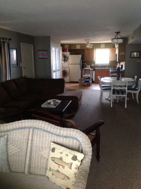 Living area into kitchen. New front load washer/dryer.