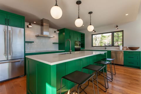Kitchen island with seating and new appliances including an induction cooktop