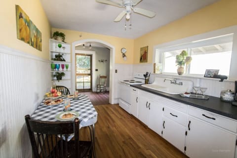 Original kitchen sink and cabinets with modern appliances. Opens to sunroom 