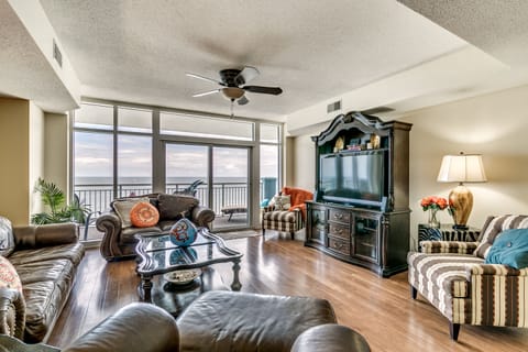 Living room w/ balcony access.