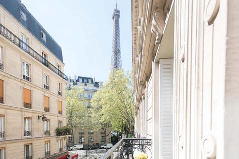 Enjoy balcony views from Monthelie overlooking Paris streets and the beautiful Eiffel Tower.