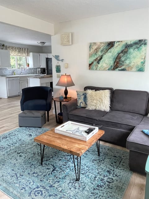 Living room has TV/sectional and open concept