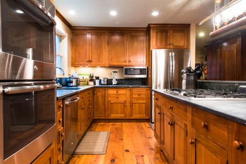 Modern spacious gourmet kitchen with double oven and natural gas range.
