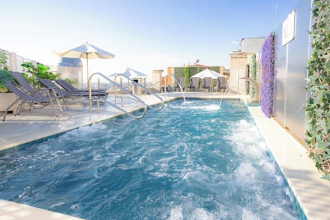 Seasonal outdoor pool, open noon to 8:00 PM, pool umbrellas