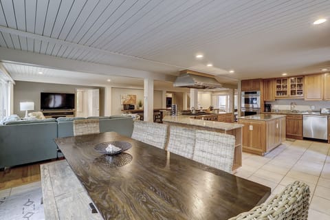 Dining table seats 10 plus 3 at kitchen counter and 4 more at second table.