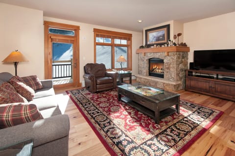 Living Room with moss rock fireplace, HDTV and queen sofa bed.