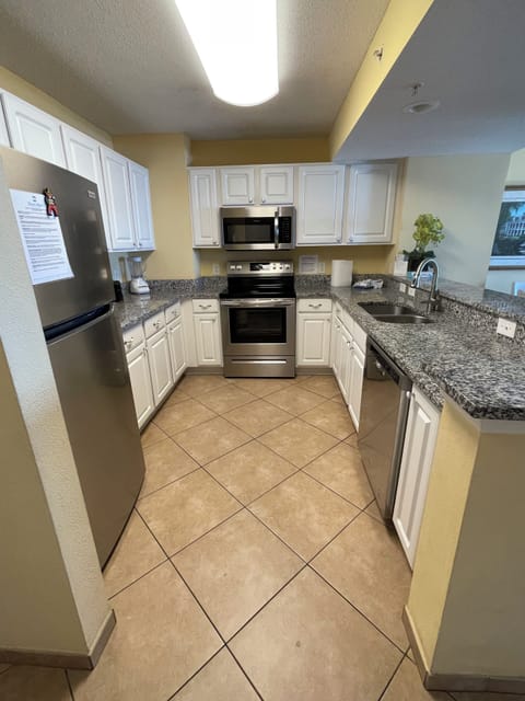 Upgraded kitchen with stainless appliances and granite countertops.