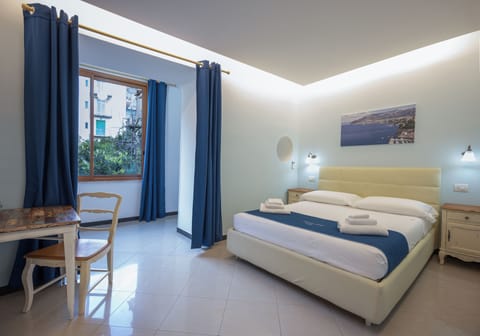 Deluxe Quadruple Room | Minibar, desk, blackout drapes, free WiFi